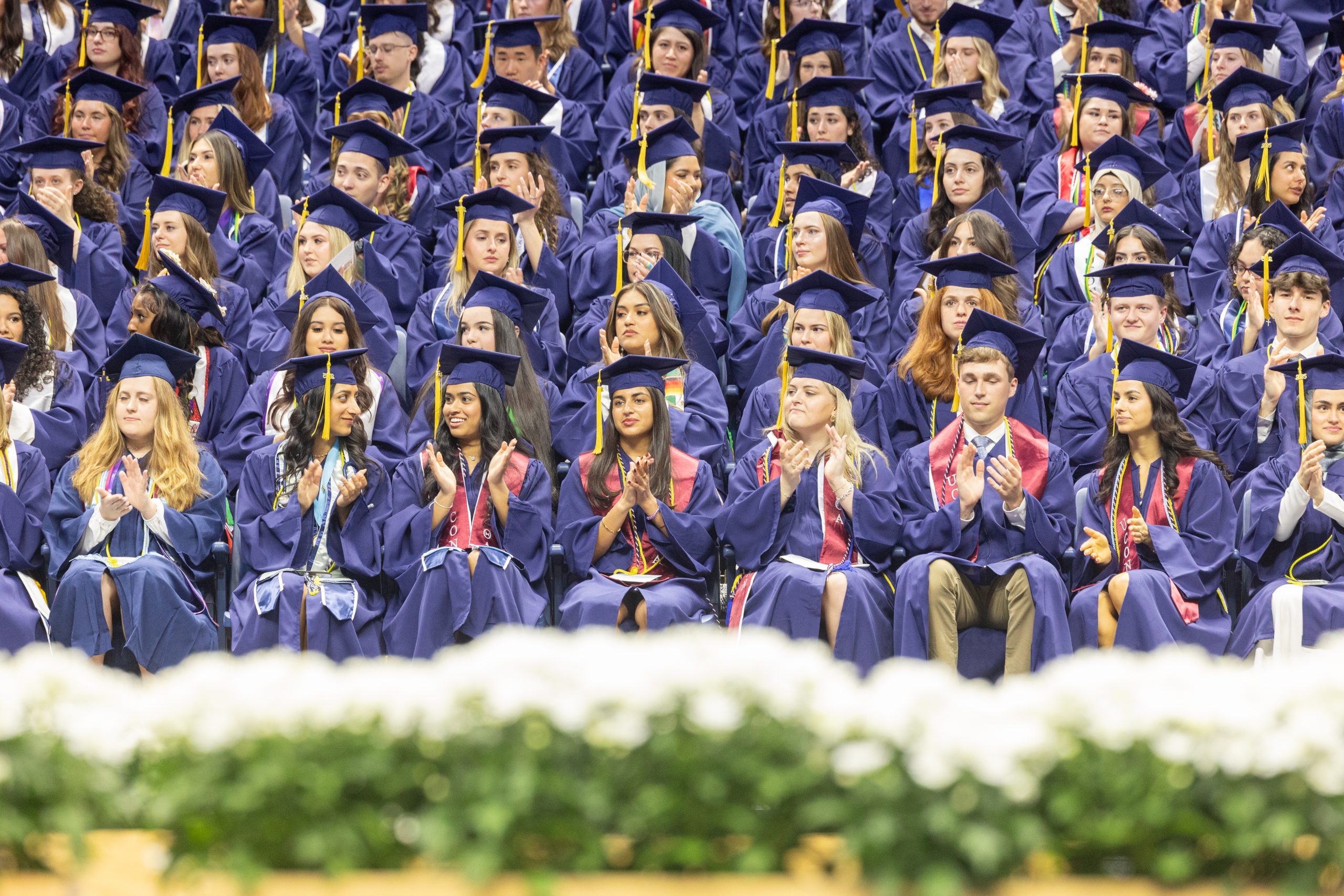 Graduates of the College of Agriculture, Health and Natural Resources sit in Gampel Pavilion during the college's Commencement ceremony on Saturday, May 10, 2025. (Sydney Herdle/UConn Photo)