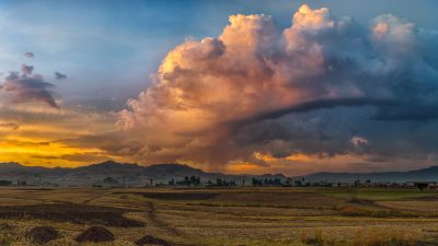 A rural lanscape with stormy clouds emerging out of the mountains during sunset near the town of Legetafo just outside Addis